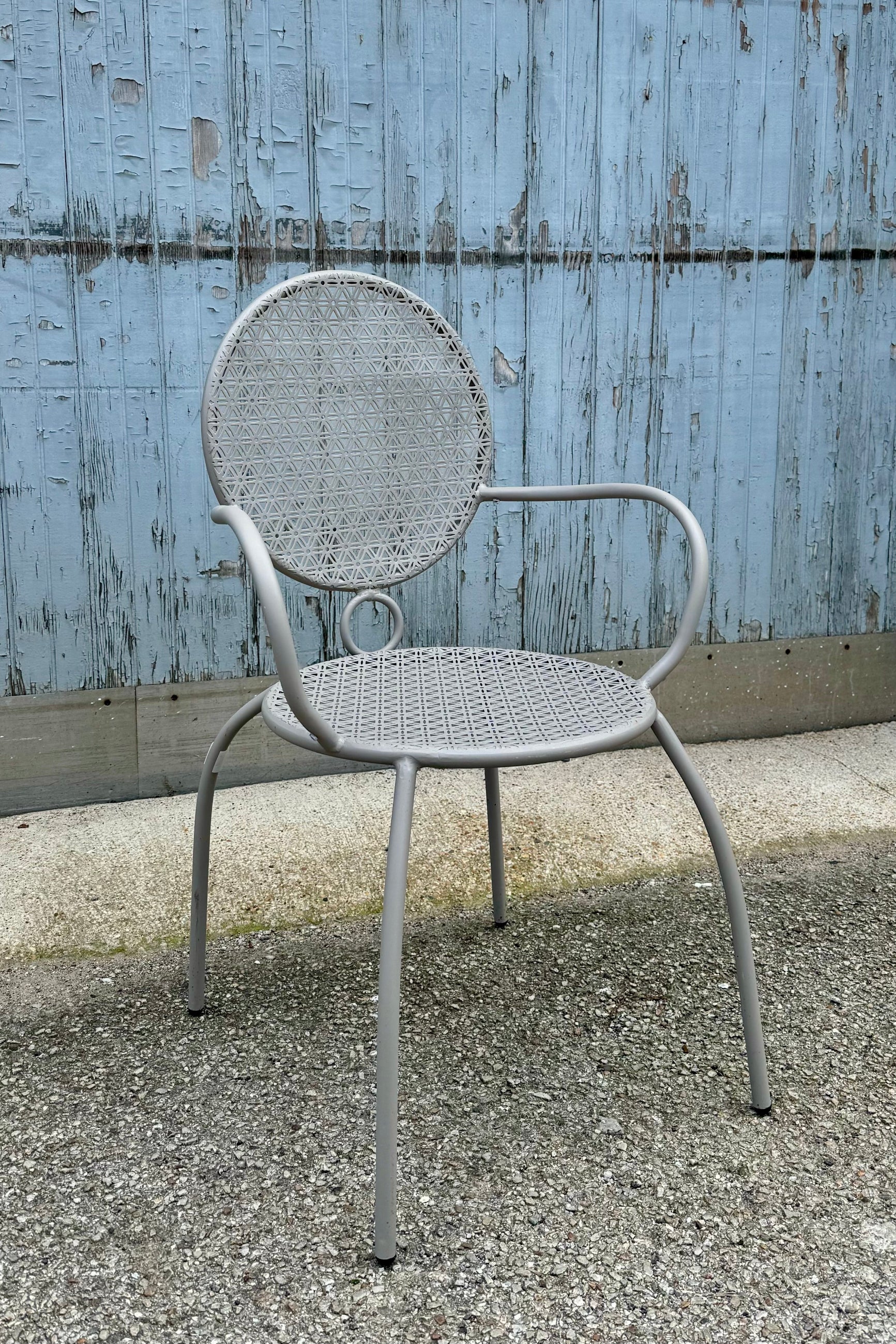 Grey bistro chair at Sprout-home sitting on a concrete floor