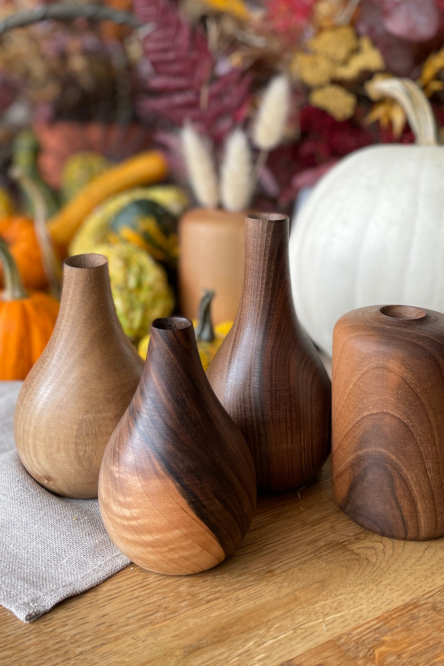 A group of handmade walnut Nina & Patti vases at Sprout-home.