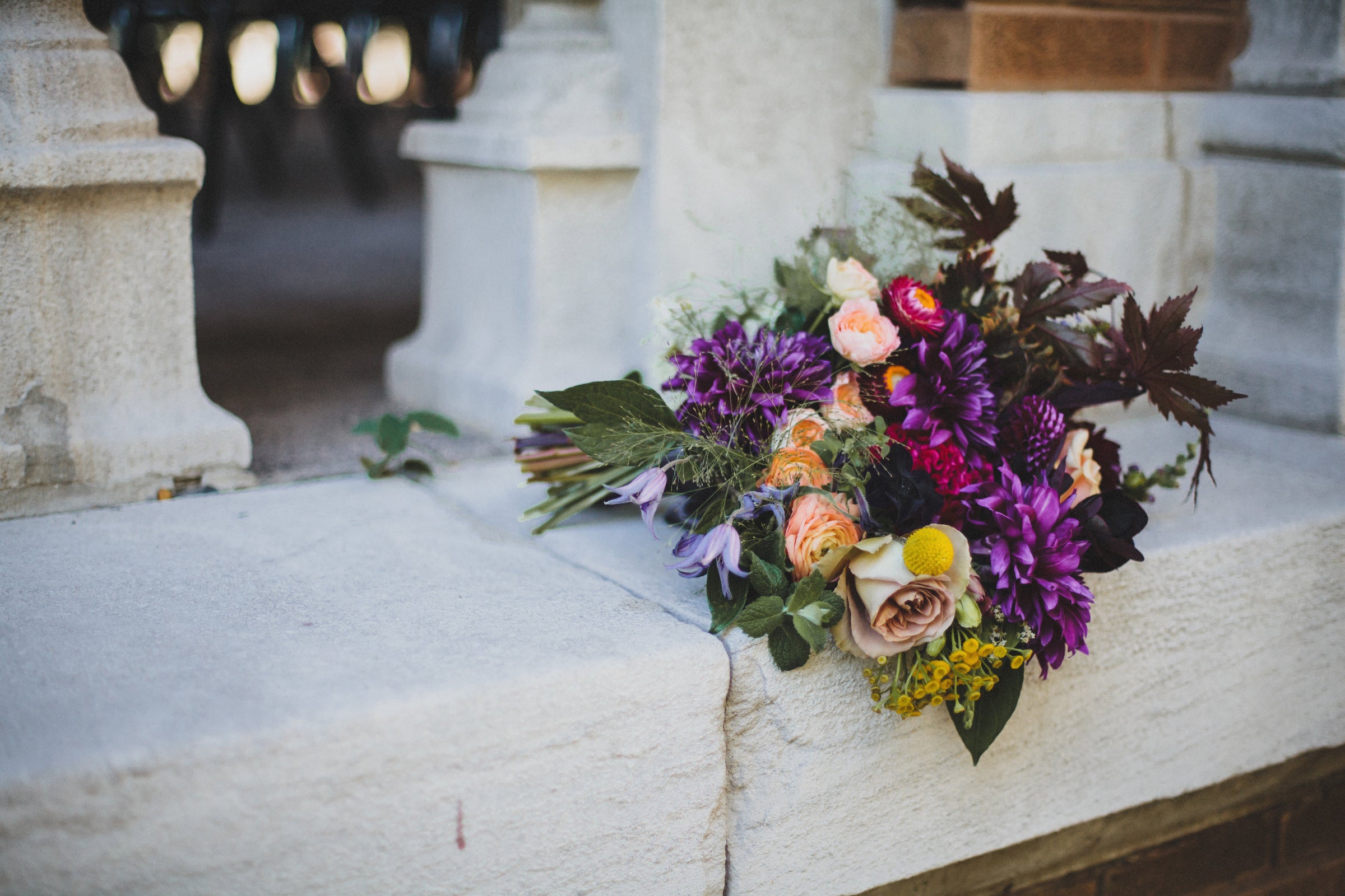 A dark purple primary color with peach and gray neutrals bouquet by Sprout-home. Photograph by Angela Renee Photography