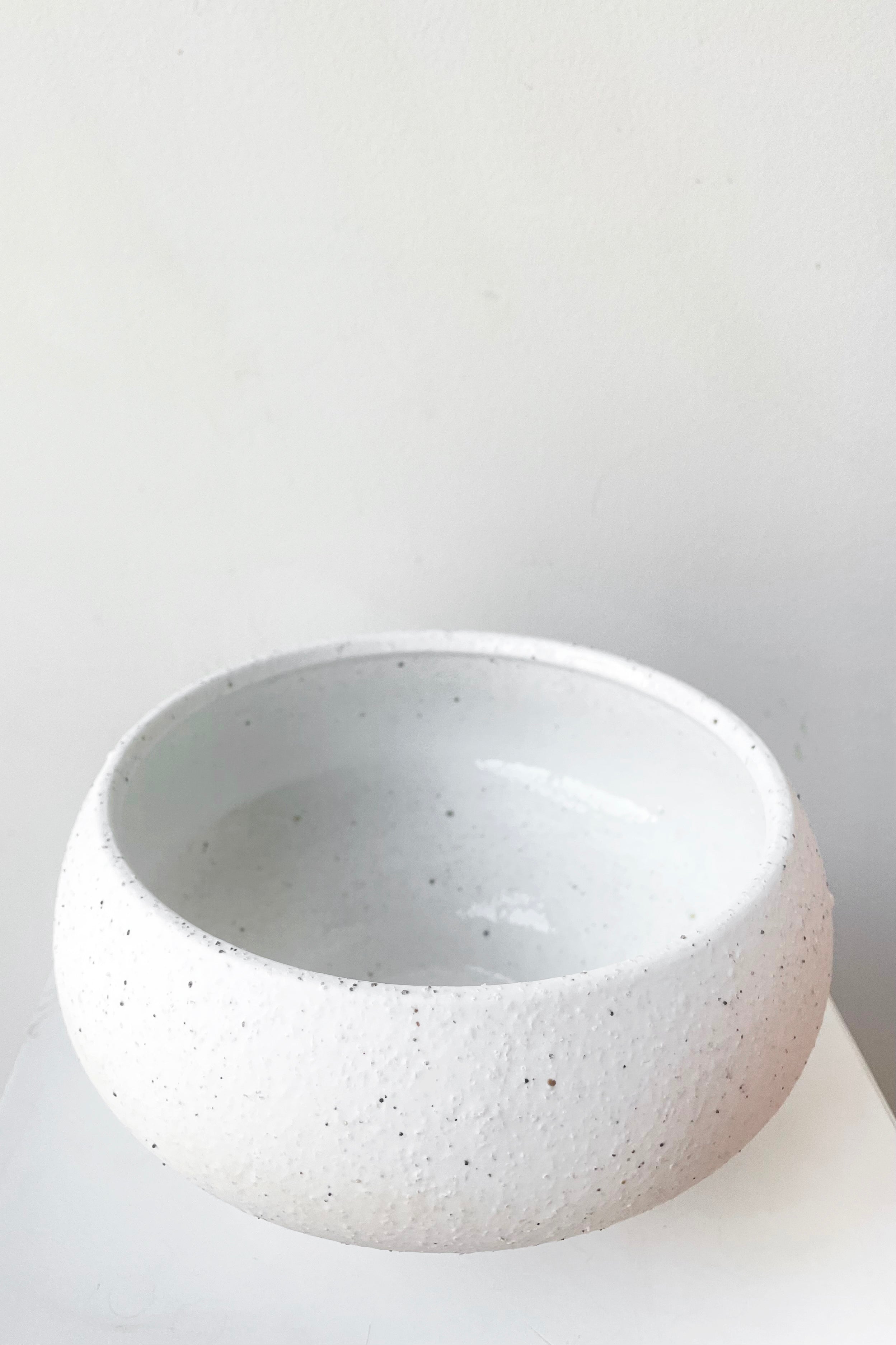 A slight overhead view of Cruz Stoneware Cachepot against white backdrop