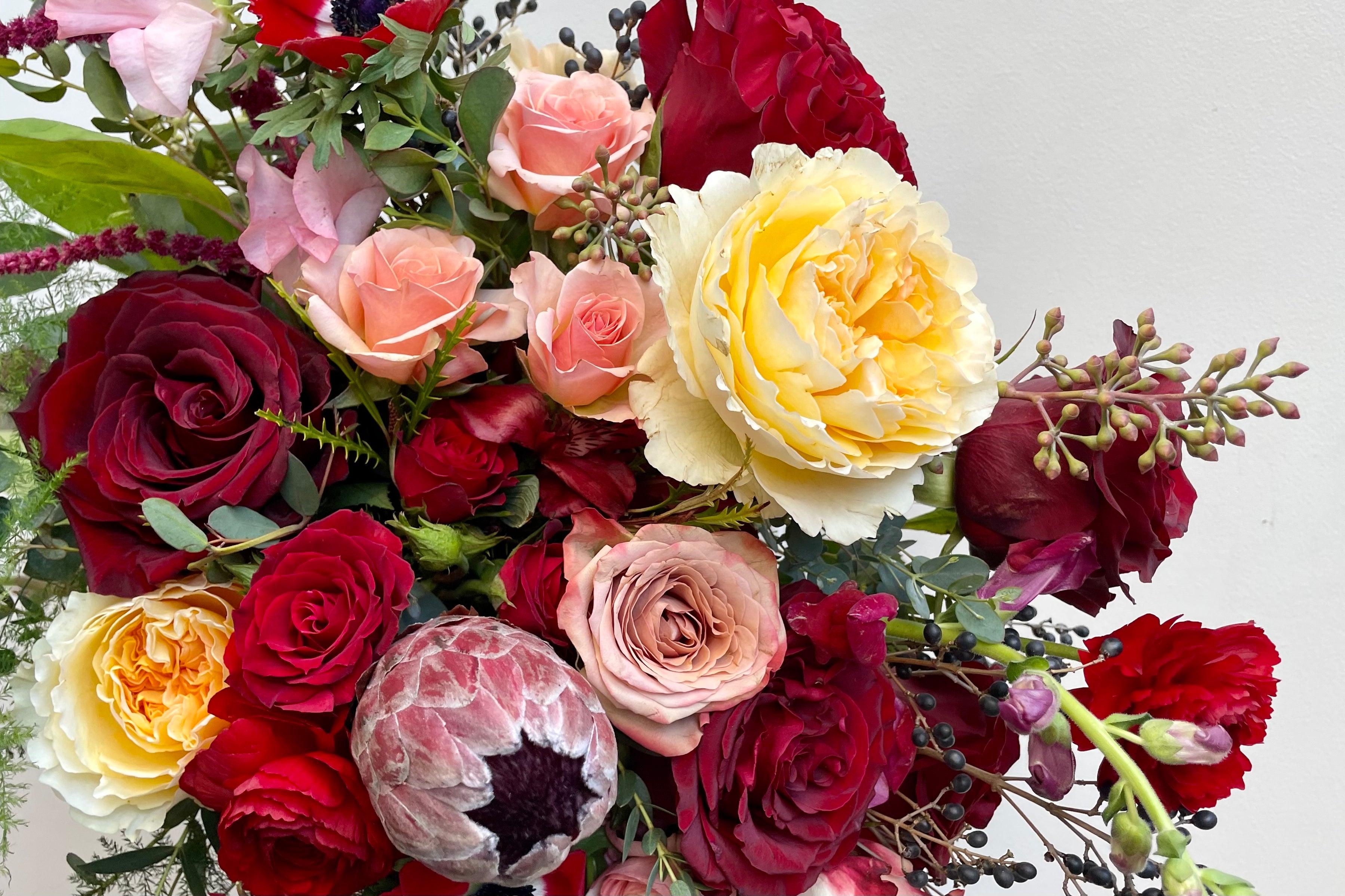 Floral arrangement for Valentines day in shades of red, nude and gold by Sprout-home.