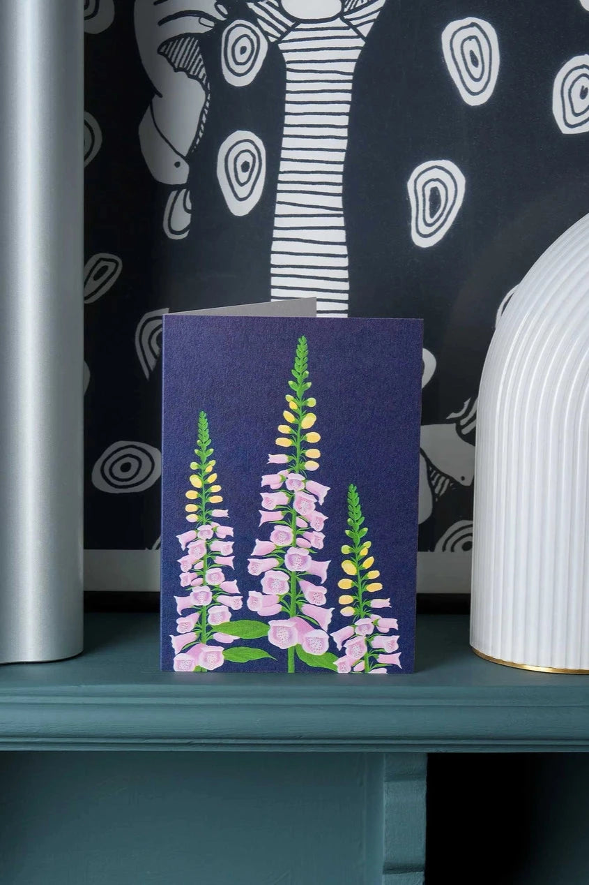 Foxglove greeting card by Stengun Drawings sitting on a shelf in a lifestyle shot.