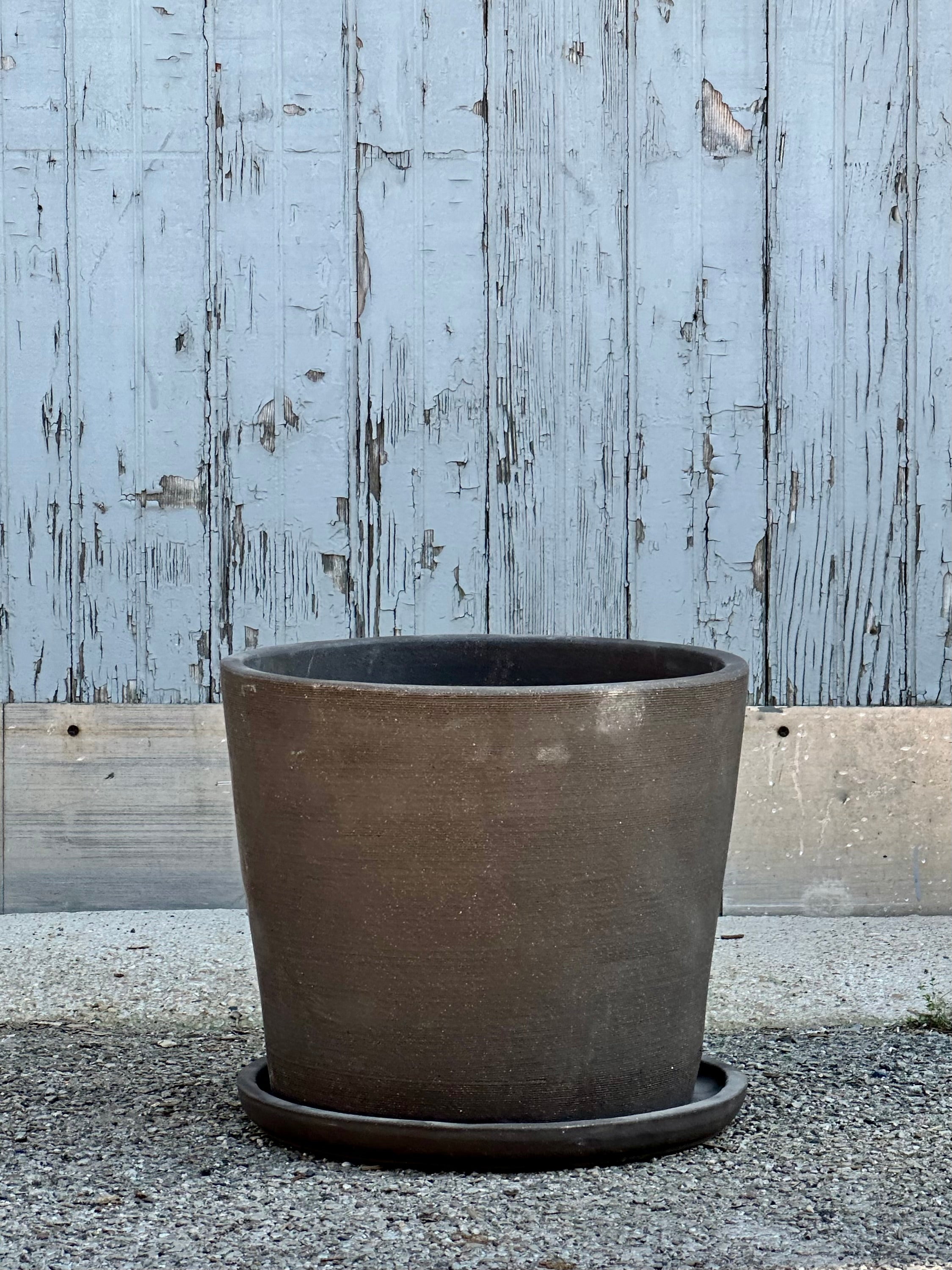 An extra large Maracay planter and saucer in a carob finish at Sprout-home shown from the side. 