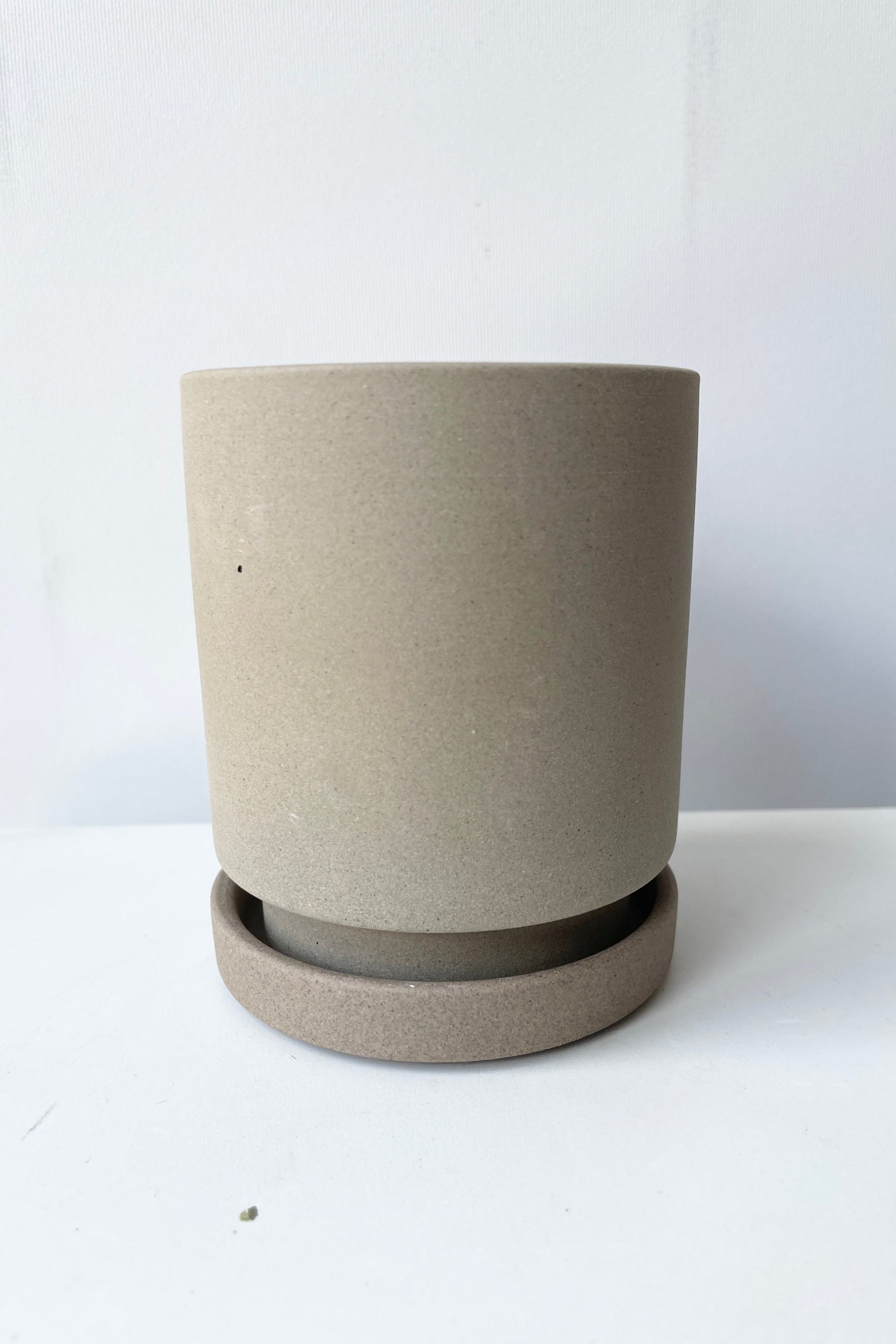 The clean lined Imogen pot and saucer shown at eye level from the side ©Sprout Home