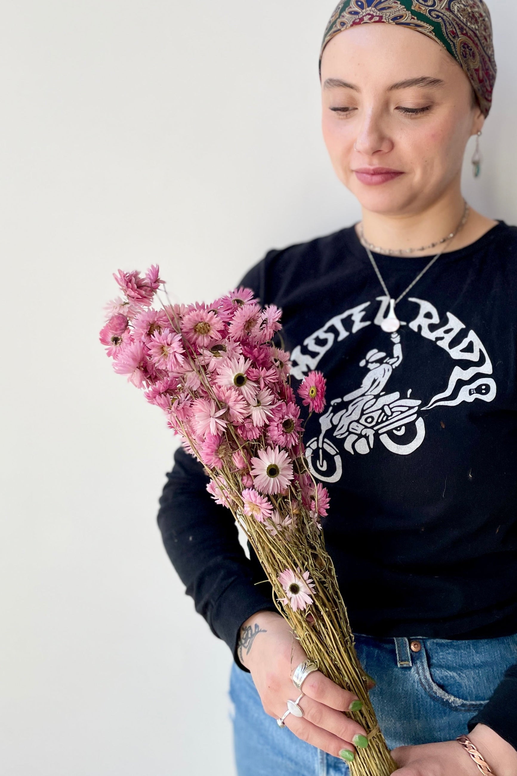 Acroclinium pink preserved bunch at Sprout-home being held by a Sprout-home associate.