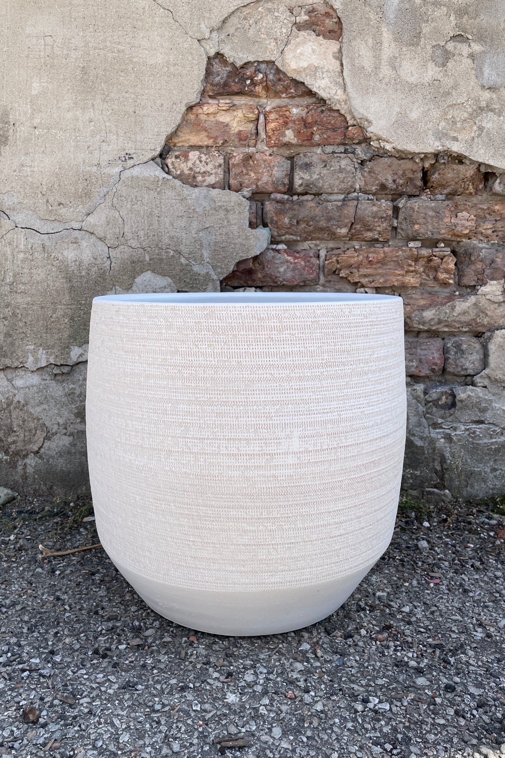 The White Ray Pot shown from the side at eye level showing the angled bottom ©Sprout Home