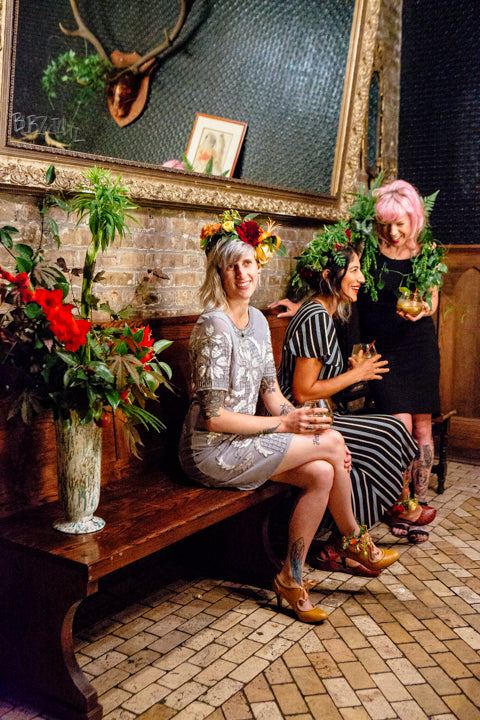 Girl's Night Out floral by Sprout-home. Floral crowns and floral anklets part of other floral.  Hip bar scene. Photographed by Heather Talbert.