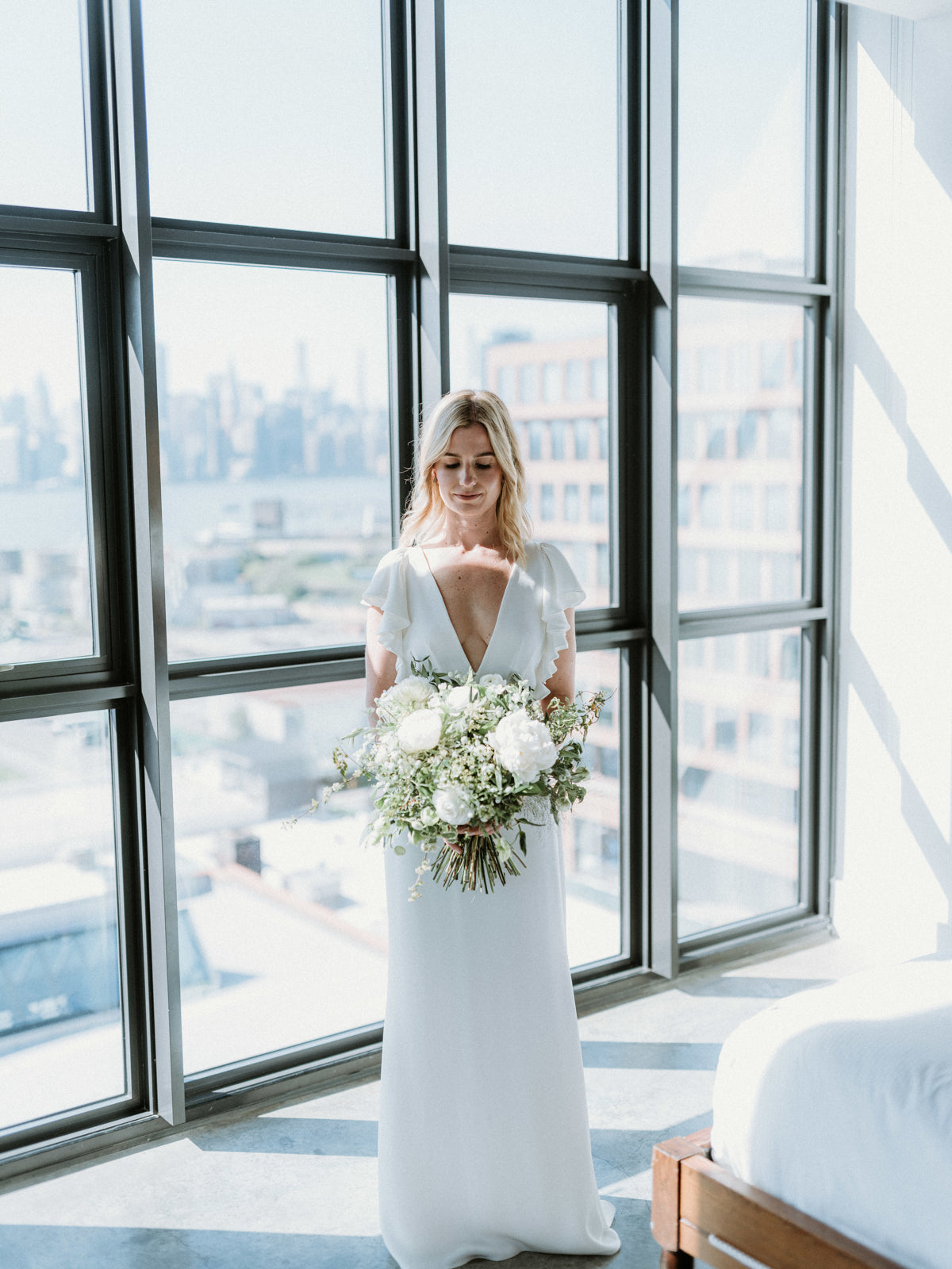 Lucas wedding with the bride holding a white bouquet from Sprout-home. Photography by Forged in the North