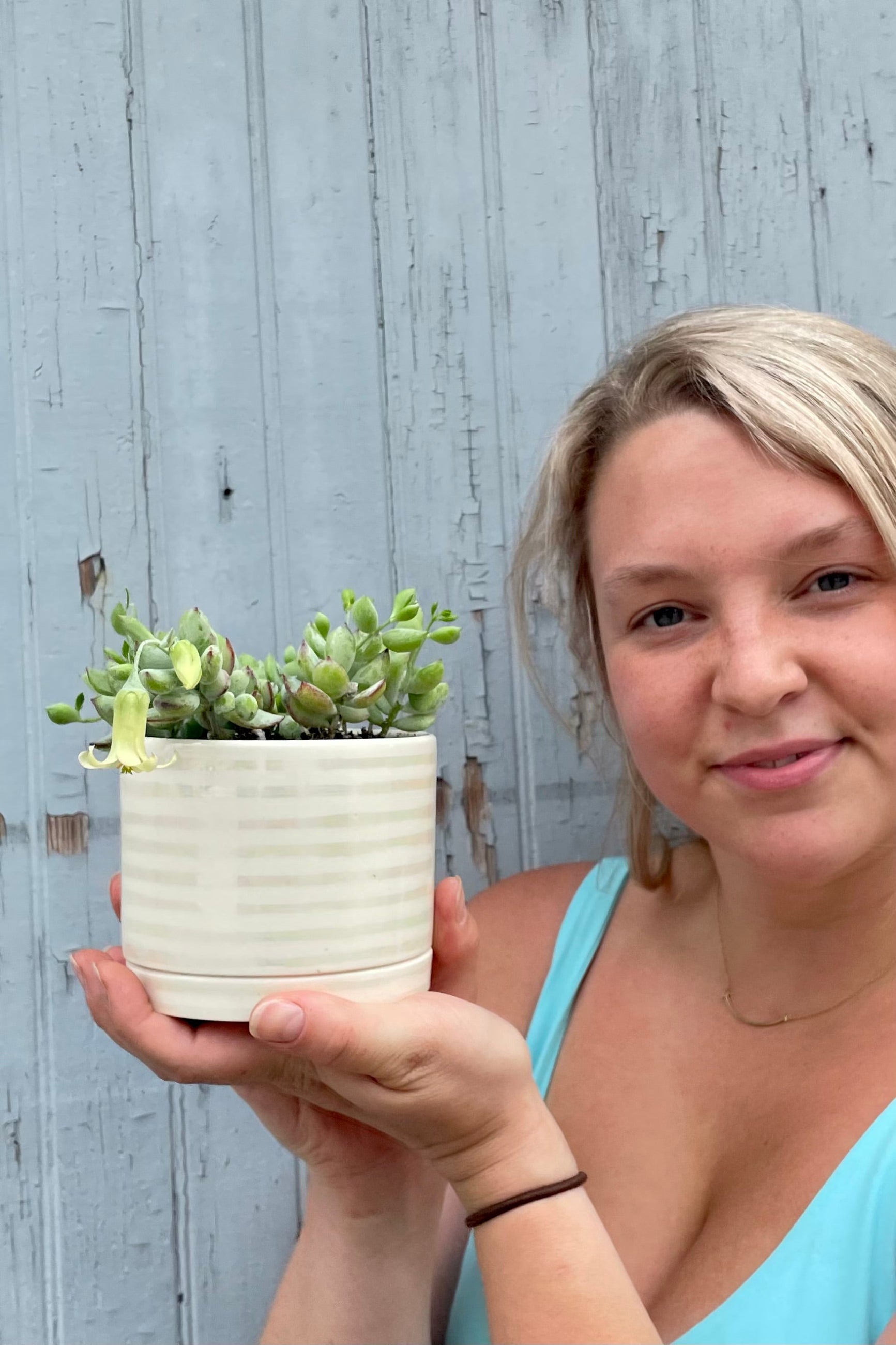 Sprout-home staff member Randi holding the Tinker Bell planting