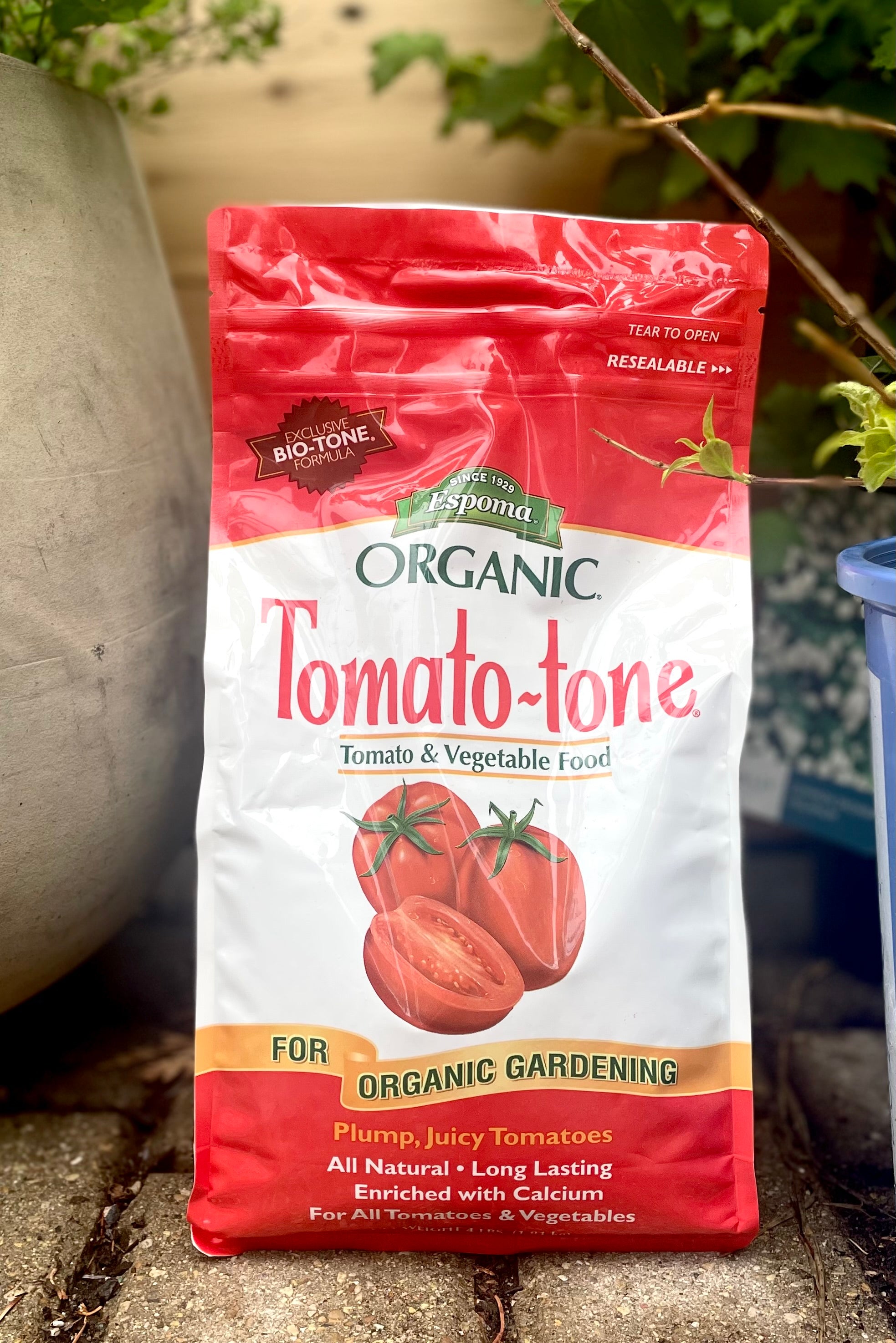 A full view of Espoma Tomato-Tone 4lb surrounded by plants