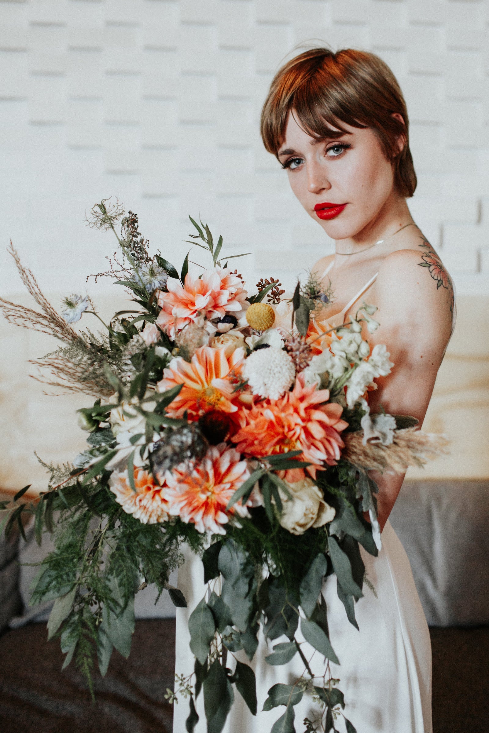 Elyssa Greg wedding floral bouquet in orange and cream by Sprout-home. photograph by Loren Weddings