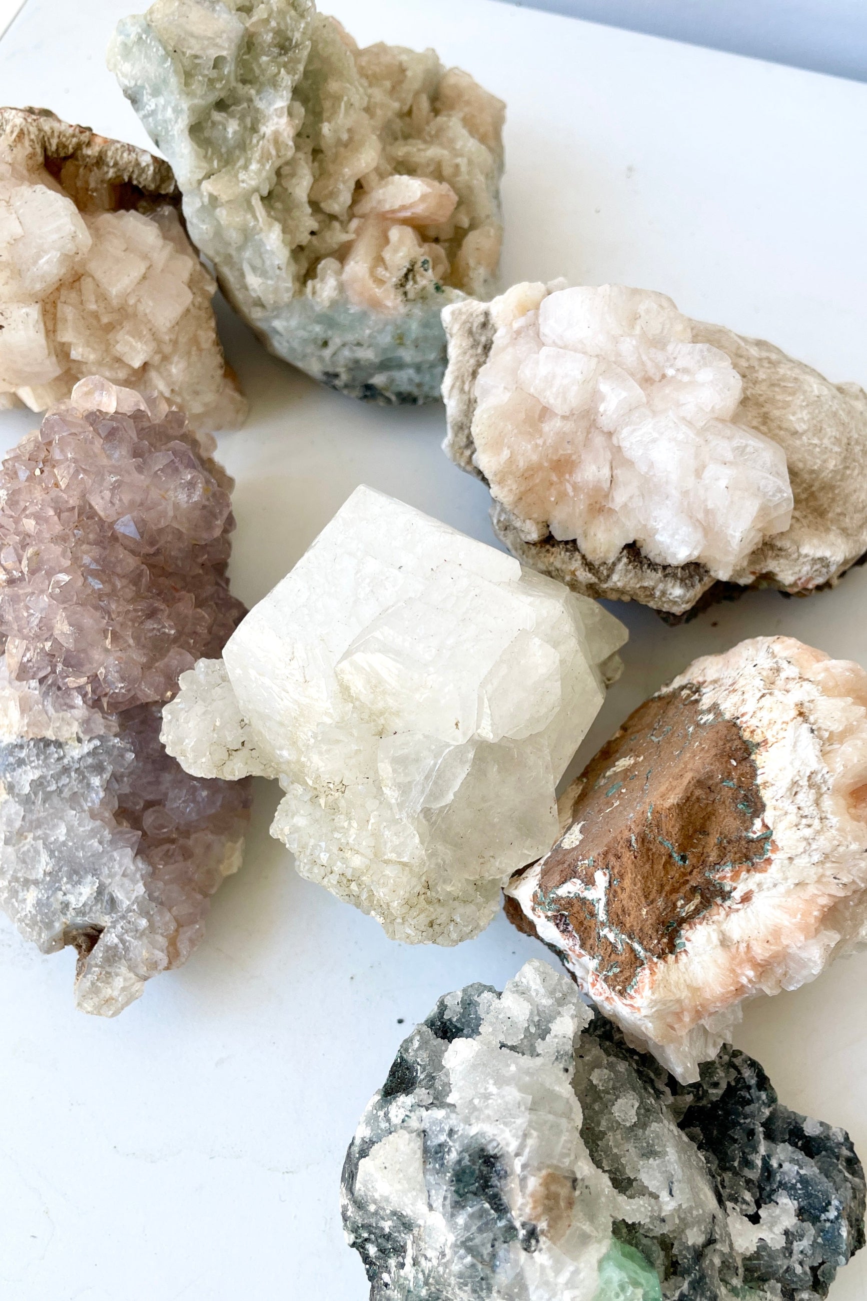 Various Zeolite Specimens on a white surface at Sprout-home.