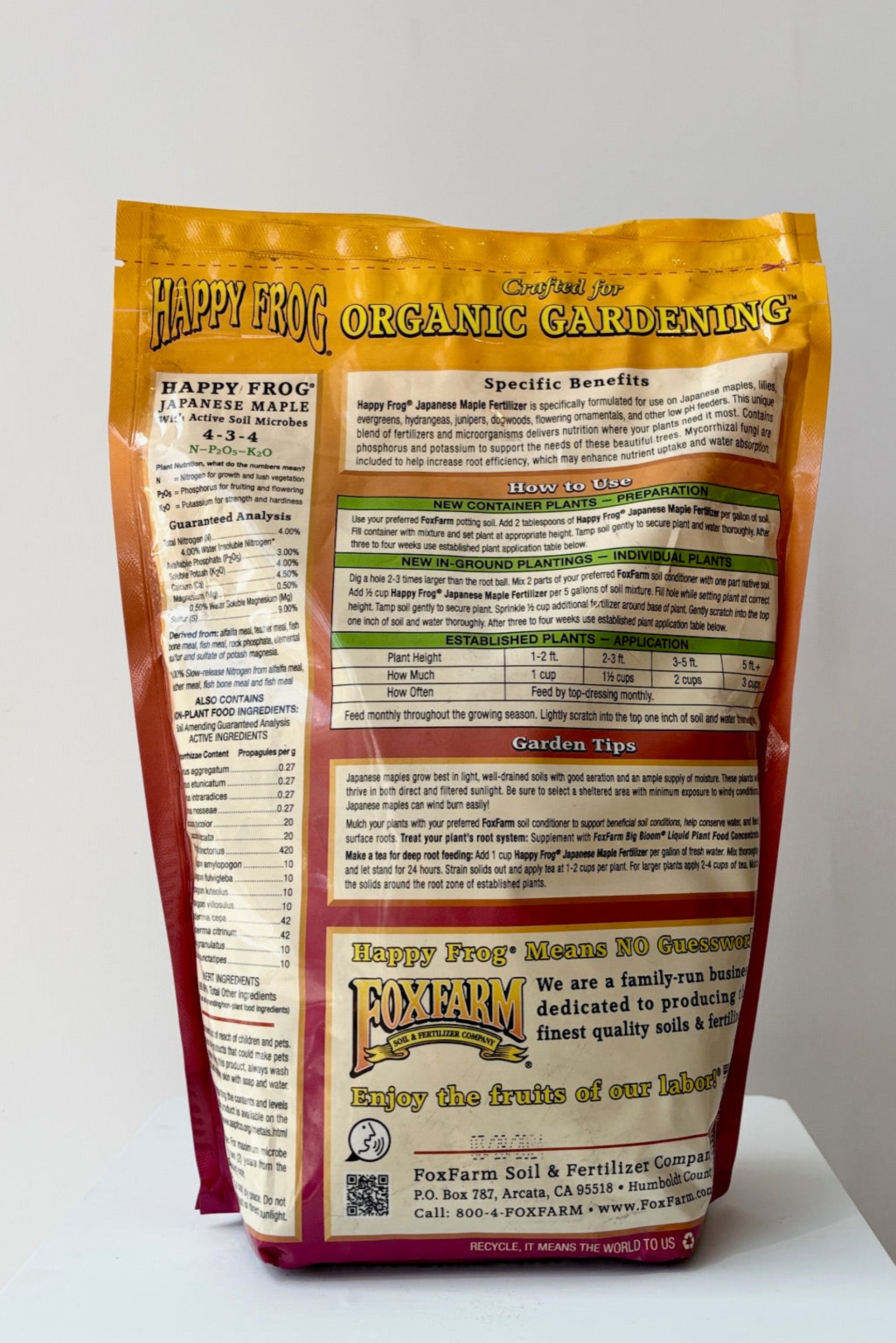 Back of Happy Frog Japanese Maple fertilizer with active soil microbes in a 4 pound bag displayed against a white wall ©Sprout Home