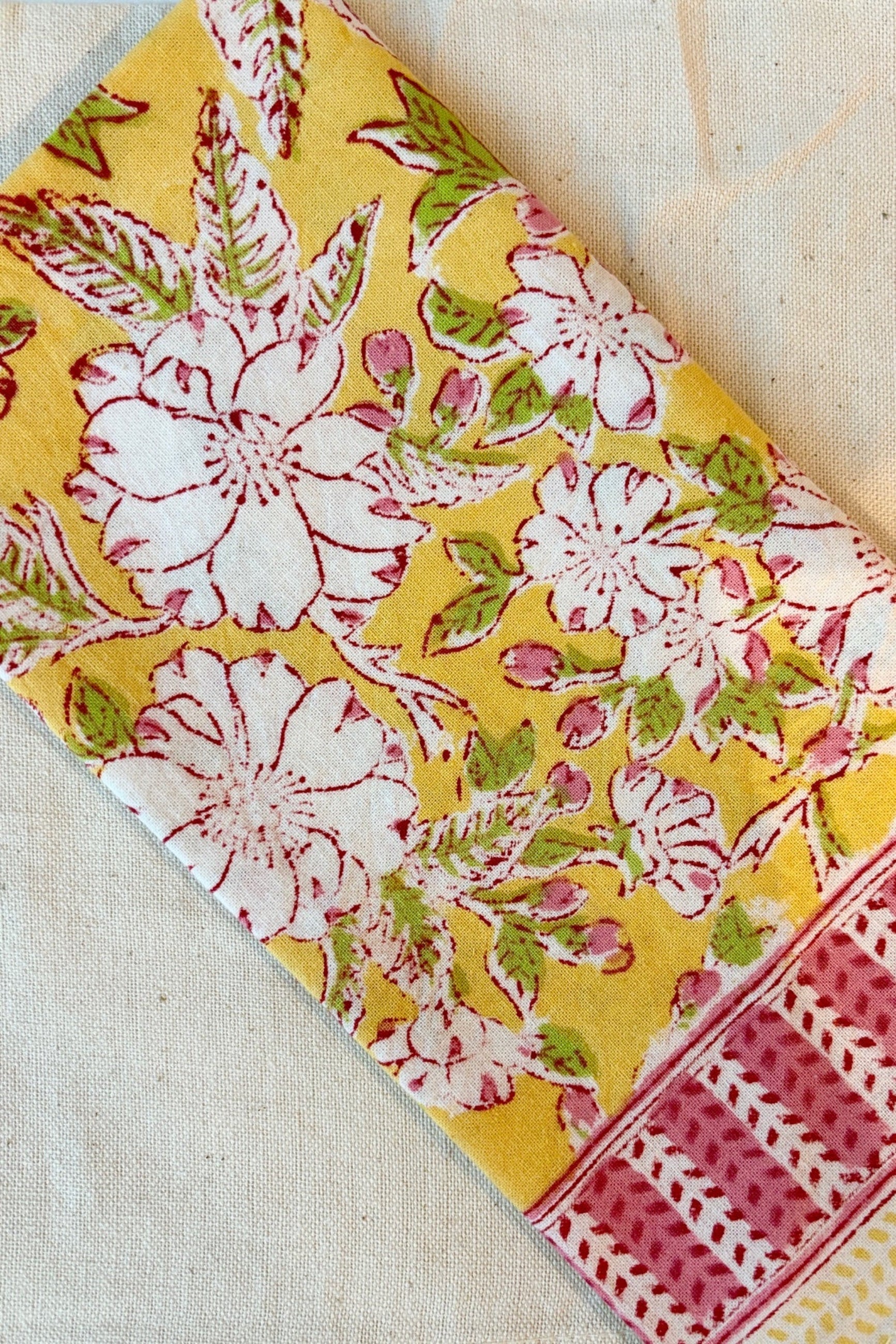 Hand printed, 100%cotton, Camelia yellow and pink floral print napkin styled with natural napkin ©Sprout Home 
