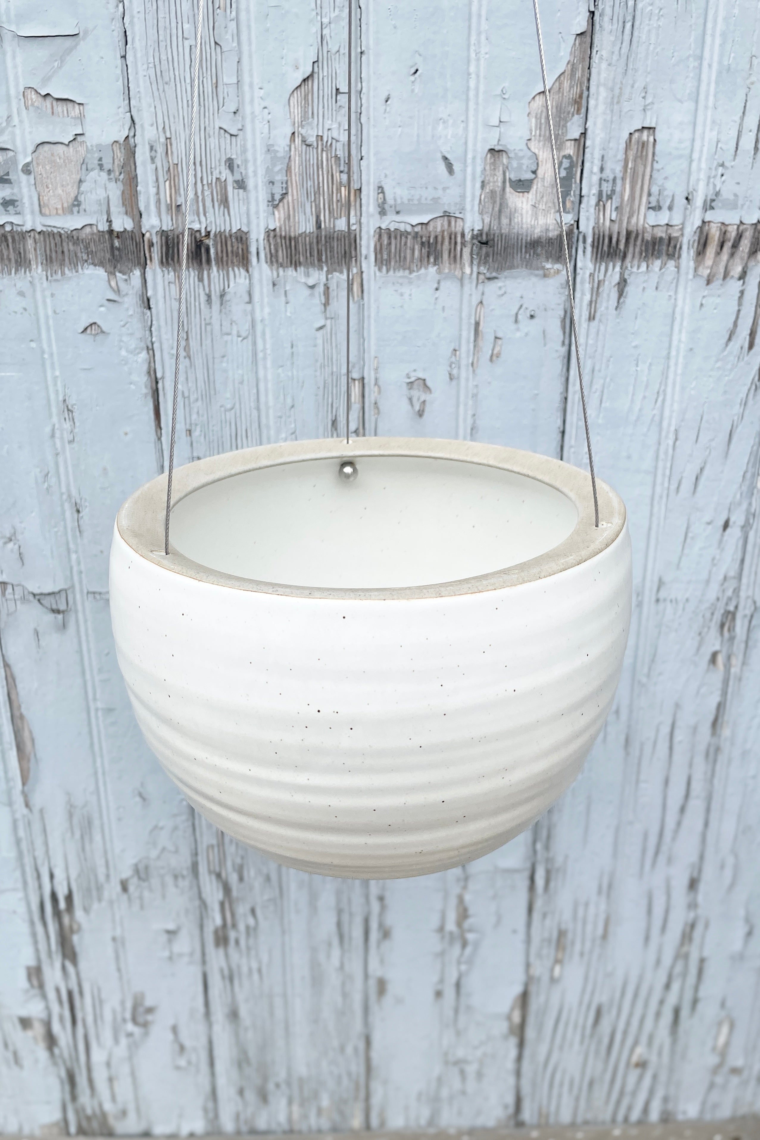 looking from the topside in to the Spherical Hanging planter in creamy white. 