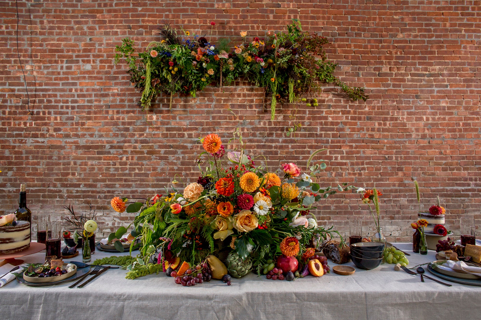 Garden Party Floral in warm shades with a wall piece and dining table. Floral by Sprout-home. Photo by Noah Kalina