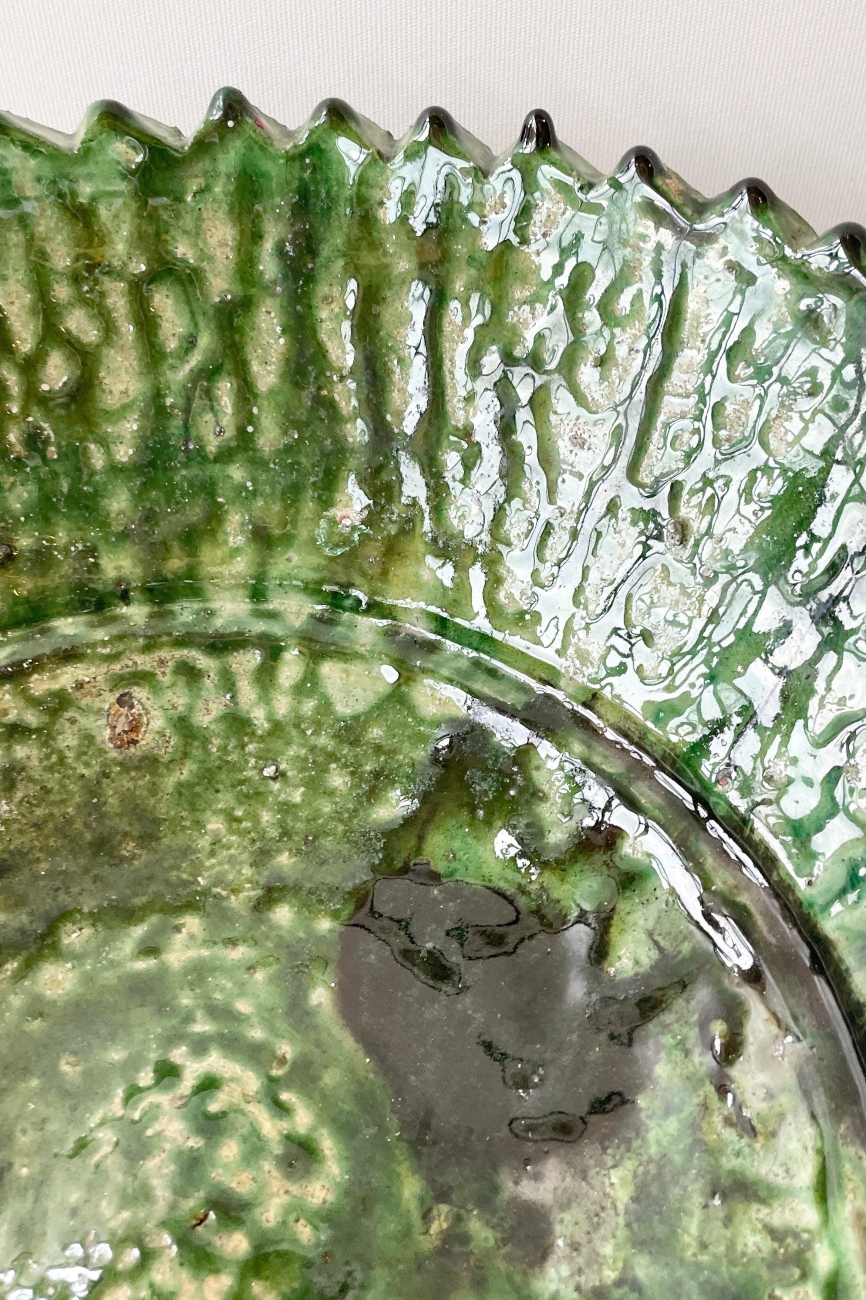 A detail image of the green mottled glaze of the the Tamegroute vessels at Sprout-home. 