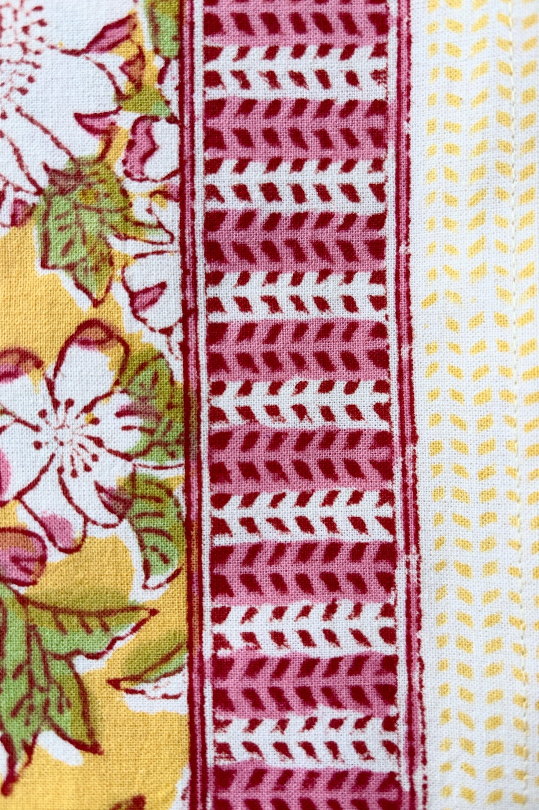Detail of trim on Hand printed, 100% cotton Camelia  yellow and pink floral print tablecloth ©Sprout Home