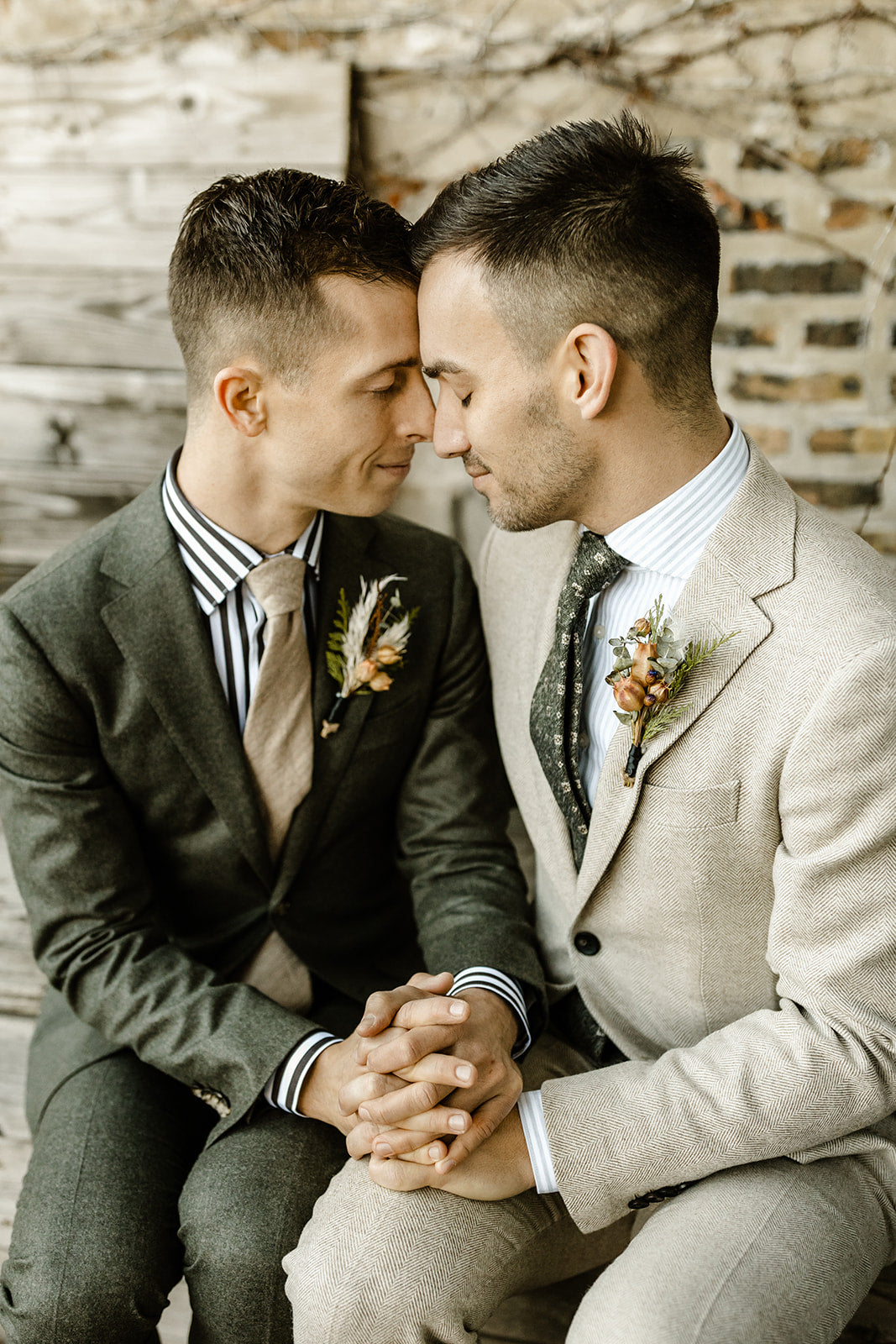 Todd & Michael elepement. Each groom in neutrals and natural green suits and natural preserved floral boutonnieres. Floral by Sprout-home. Photograph by TMInspired Photography