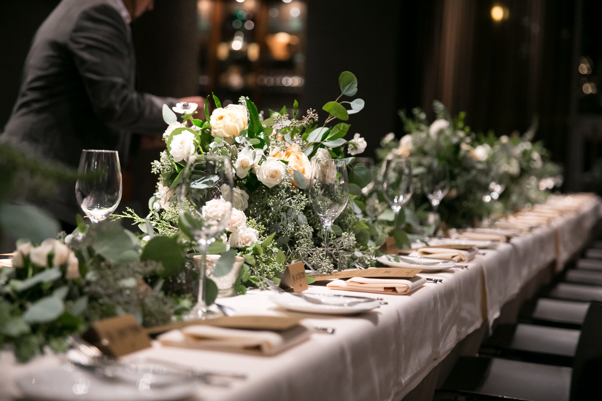 Zachery and Brians wedding with a reception table garland that is thick and lush with greenery and cream garden roses, lush and plush.  Floral by Sprout-home. Photograph by Slack Photography LLC