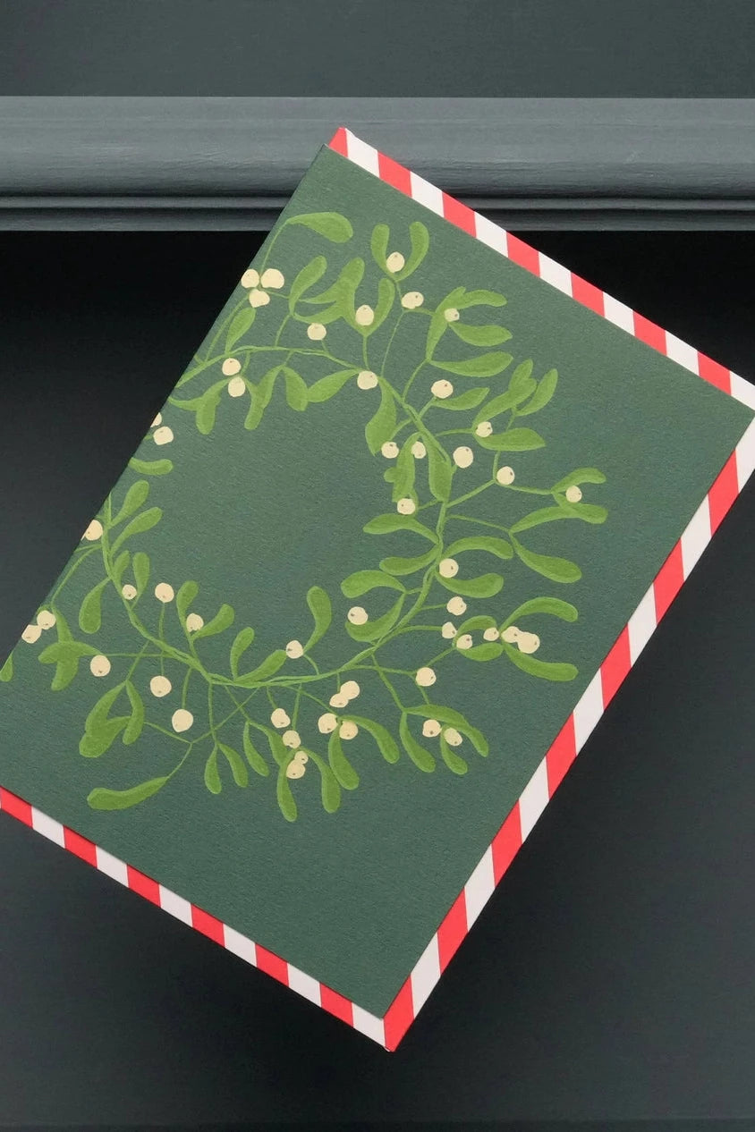 Holiday mistletoe wreath card by Stengun Drawins viewed from the front. 