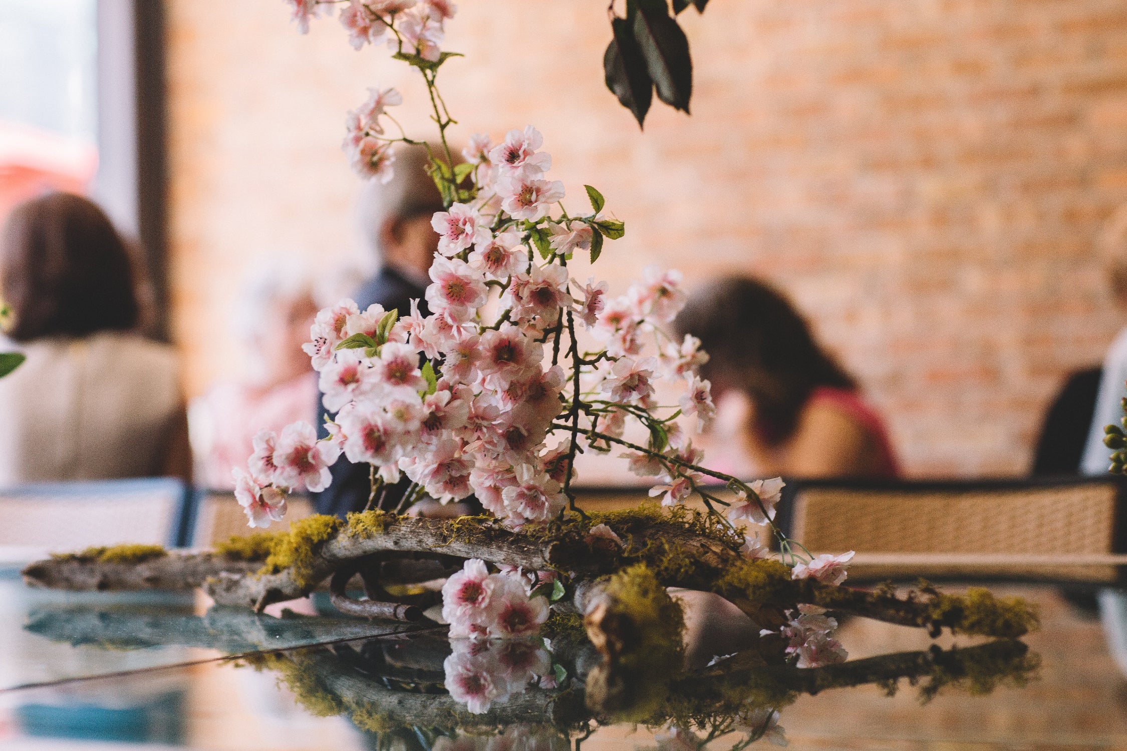 flowering branch and moss covered wood installation by Sprout-home. Photograph by Stephanie Bassos