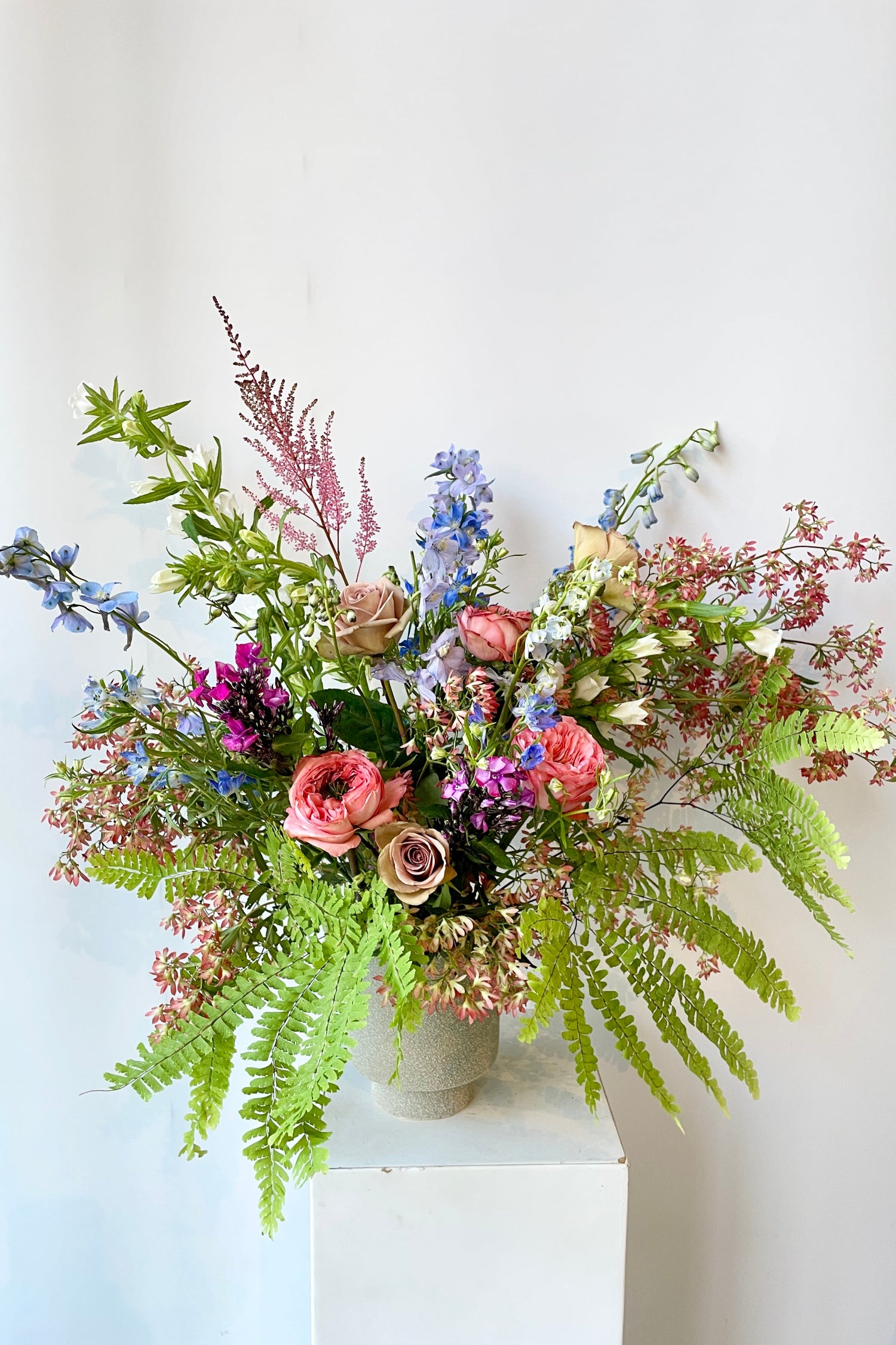 Floral arrangement by Sprout-home featuring delicate fern and pastel floral. Photo by Sprout-home.