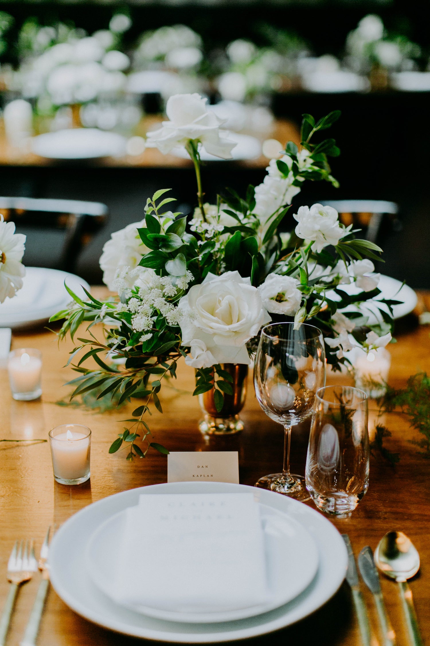 Claire & Mikes wedding at 501 Union in Brooklyn, white floral with dark green foliage in gold vessel on top of wooden table centerpieces. Classy and rich. floral by Sprout-home.  Photograph by Amber Gress