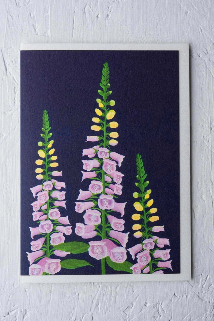 Foxglove greeting card by Stengun Drawings viewed from the front against a white wall. 