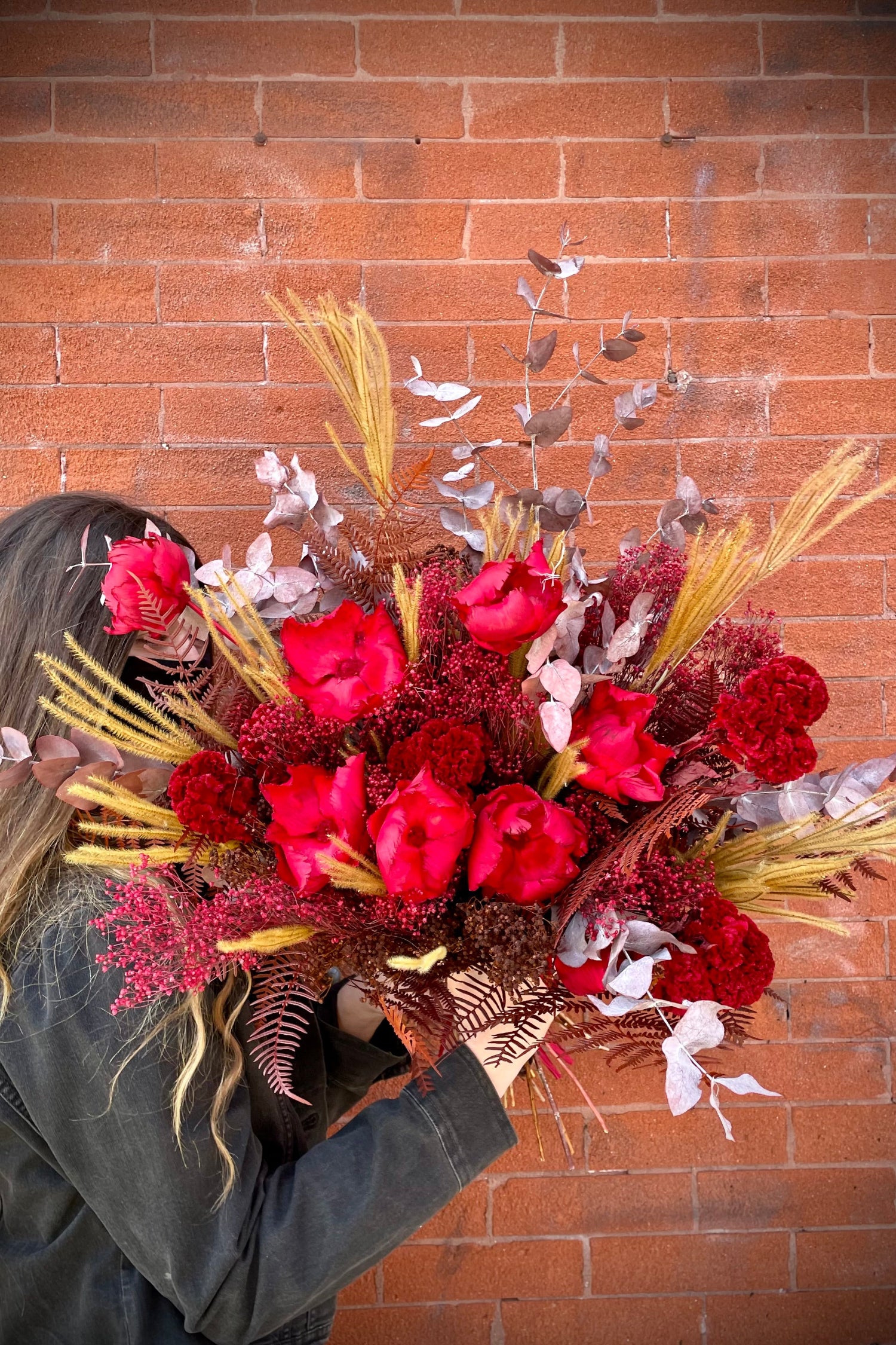 Preserved arrangement Red Velvet by Sprout-home being held in hand. Photo by Sprout-home. 