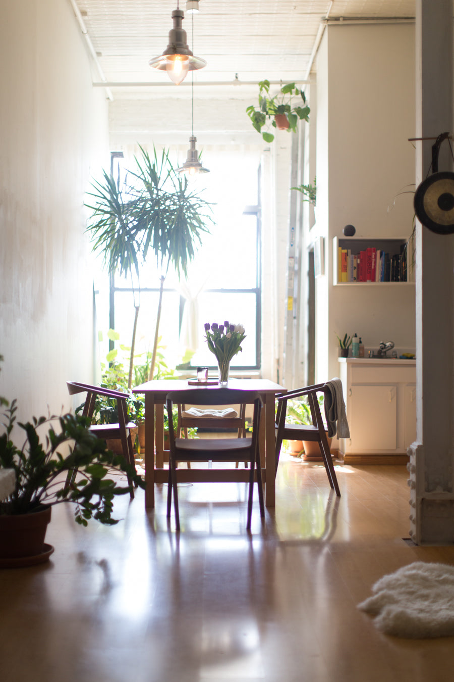 A modern Scandinavian style room with various plants around the space to compliment by Sprout-home