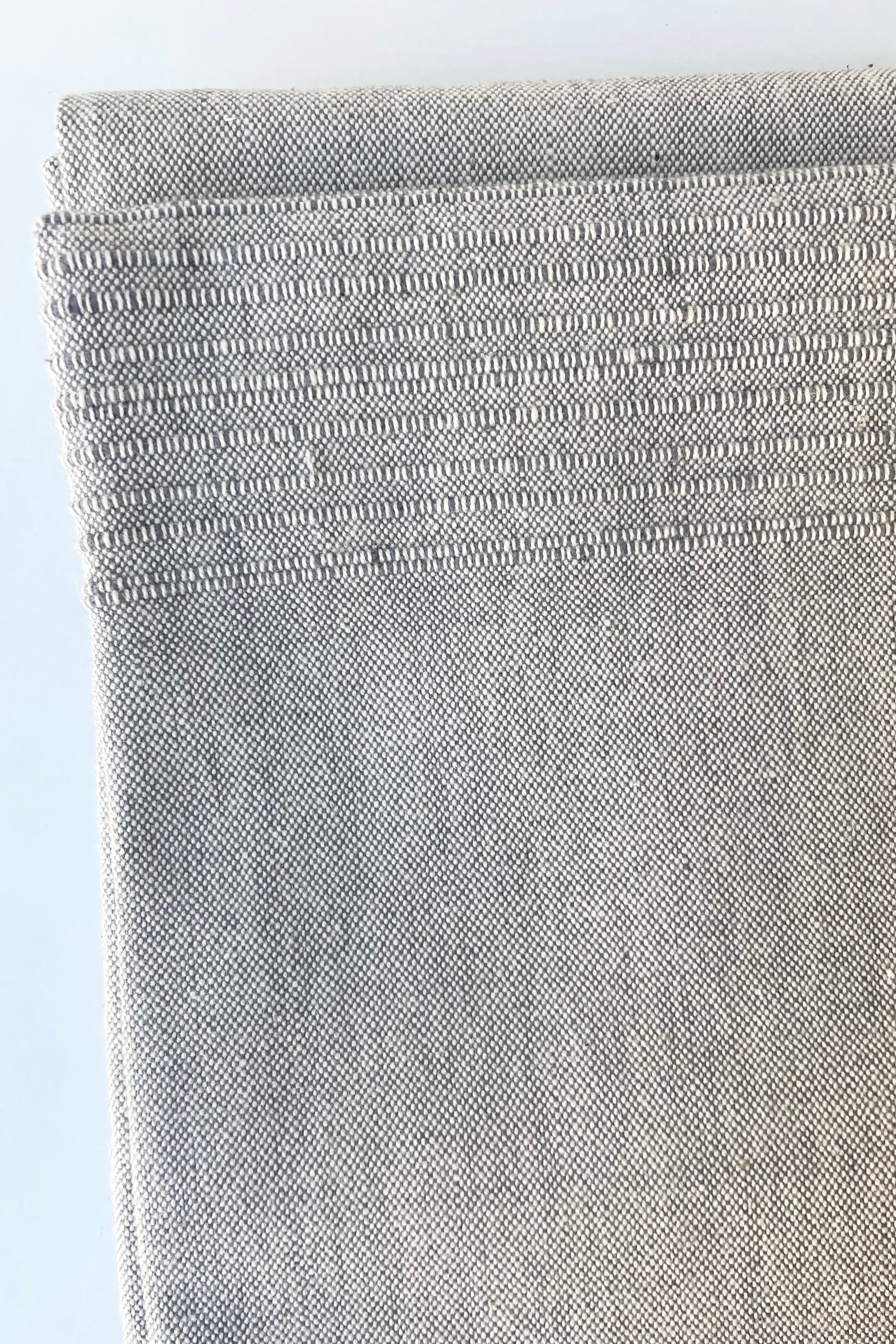 detail of the Tablecloth sea salt large against a white wall
