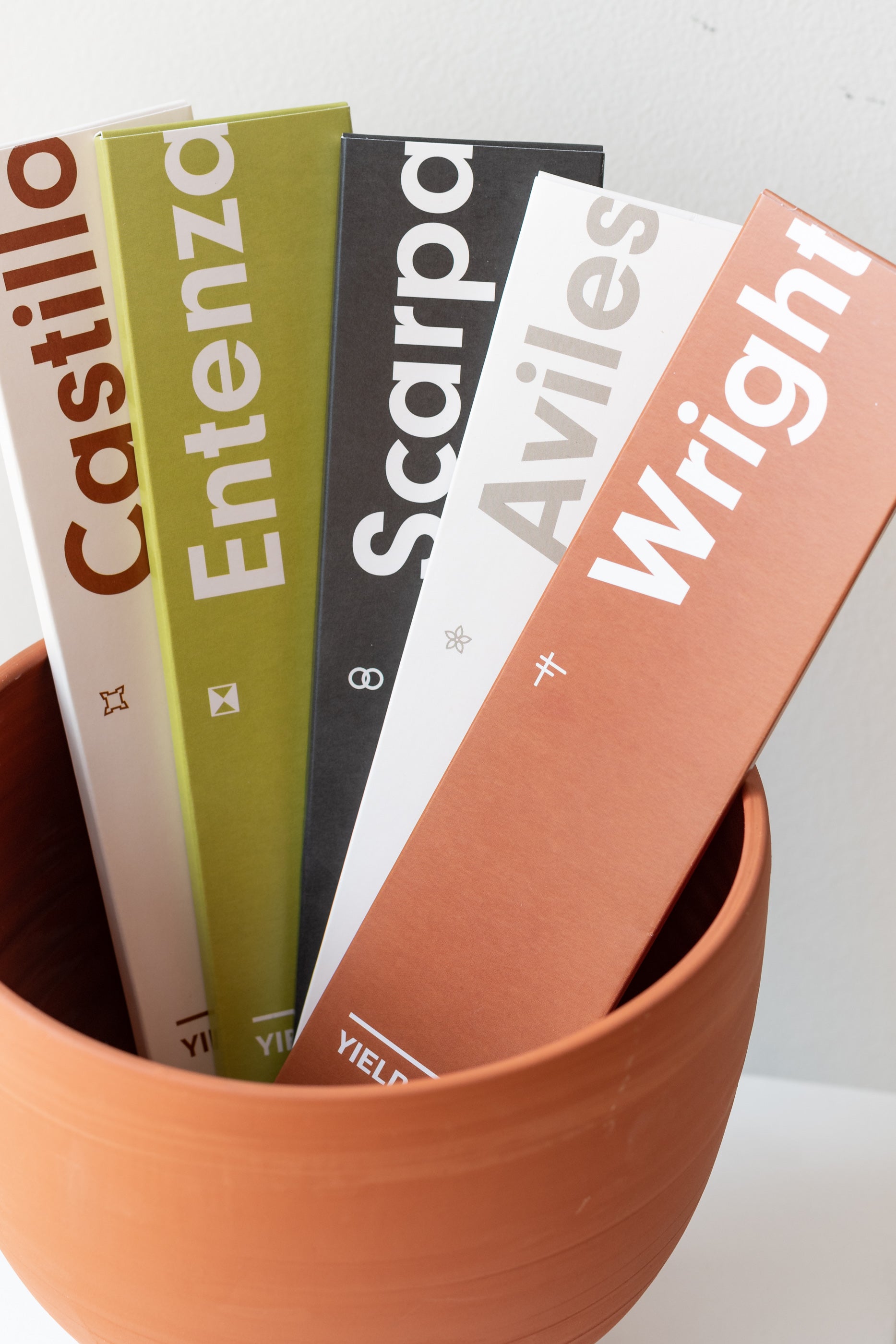 Variety of YIELD incense sticks, including Castillo, Entenza, Scarpa, Aviles, and Wright, in a terra cotta container