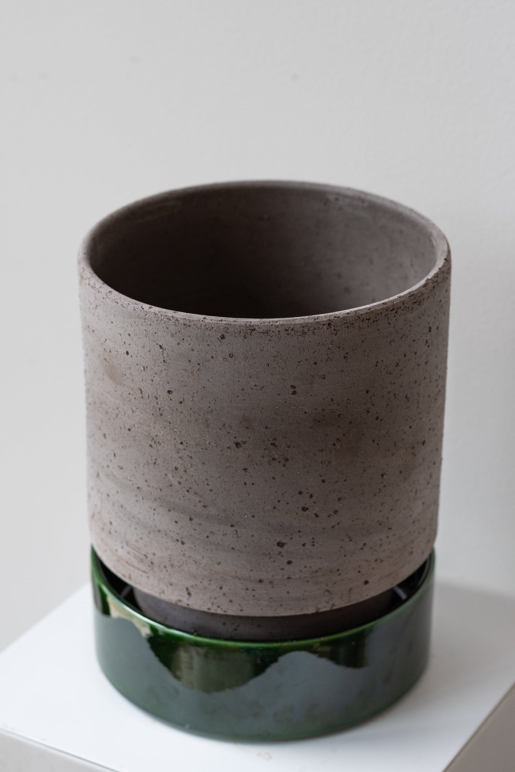 Bergs Potter Hoff Pot & Saucer grey & emerald on a white surface in a white room