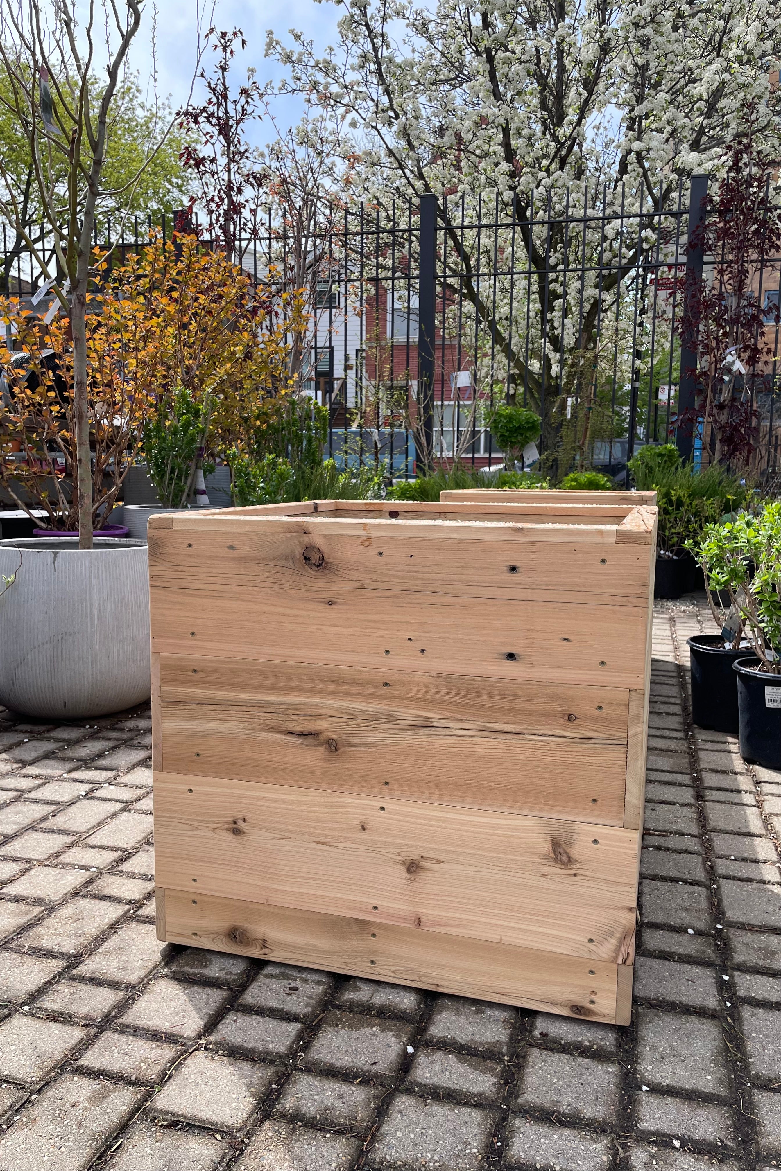 The 26" square cedar handmade planter shown empty at Sprout-home.