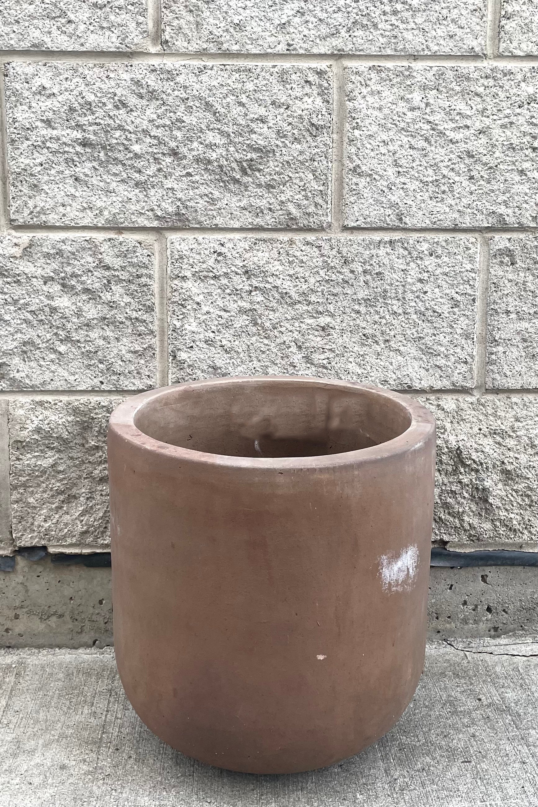 A full frontal view of Dora Planter Medium against concrete backdrop
